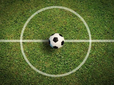 Soccer ball on the grass of a stadium to illustrate the context of the rights of the accused.