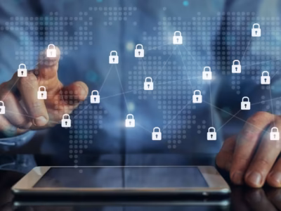Person using a tablet with connected padlock icons over a world map to represent data protection.