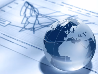 Crystal globe on blue financial charts, representing sustainability and technological innovation.