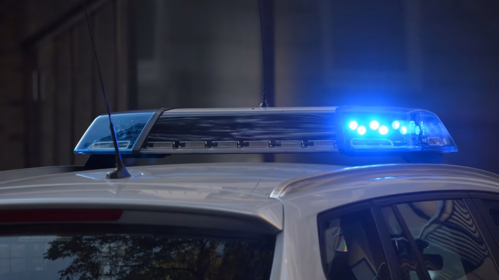 Blue lights of a police car. Urgent legal assistance for detainees.