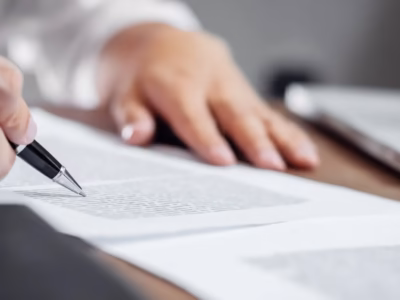 Hands with a pen reviewing free legal forms for citizens on offer.