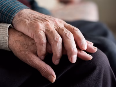 Intertwined hands of elderly people representing legacy and digital will in inheritance.