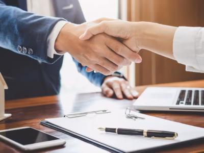 Handshake between lawyer and client symbolizing a judicial victory and successful legal agreement.